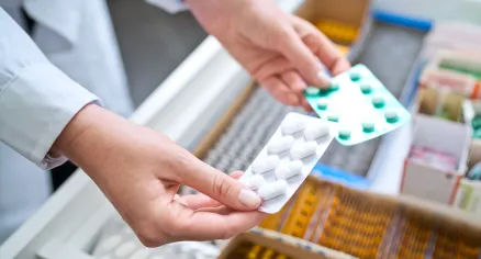 Image of person holding blister packs.